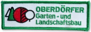 Rechteckiger Aufnäher mit vorwiegend Text und kleinem ergänzendem Motiv