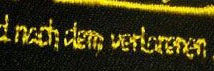 Gelbe Schrift auf schwarzem Aufnäher - schlecht lesbar